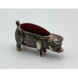A silver pin cushion in the form of a pig marked 925 to base