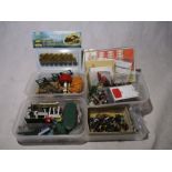 A collection of model railway scenery and figures including telegraph poles, people, animals, hay