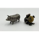 A novelty tape measure in the form of a pig along with a pin cushion modelled as a frog holding a