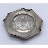 A hallmarked silver ashtray by the Goldsmiths and Silversmiths Company, London with glass liner