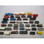 A collection of OO gauge rolling stock including tankers, coal wagons, crane etc along with two