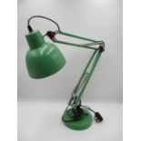 A modern green angle poise lamp