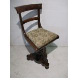 A Victorian rosewood piano chair