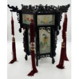A Japanese hanging hexagonal lantern , each side with a glass panel painted with a traditional scene