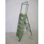 A vintage green painted step-ladder