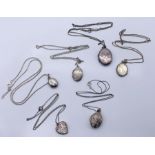 A collection of six silver lockets on chains