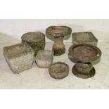 A collection of various concrete garden pots, bird baths etc