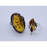 Two 925 silver rings set with amber