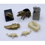 A collection of novelty pig themed items including a brass nib brush in the form of a seated pig,