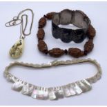 A small collection of costume jewellery including a Sterling silver bracelet and a carved nut