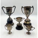 Four hallmarked silver trophies along with a silver plated version