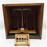A cased set of W & J George & Becker Ltd (London & Birmingham) balance scales with box of weights