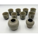 A collection of Oriental pottery including a set of 8 Japanese style Saki bowls along with a