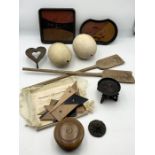 An assortment of items including antique ostrich eggs, lacquered trays, vintage protractor etc