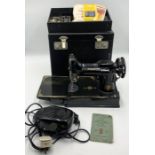 A singer 221K portable sewing machine in original box with pedal and accessories