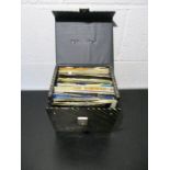 A carry case full of 7" vinyl singles including Genesis, George Harrison, Elvis Presley, The Beach