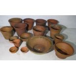 A collection of terracotta flower pots and bowls