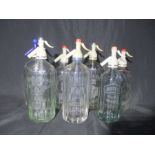 A collection of 7 vintage glass soda siphons each with etched decoration