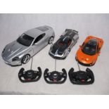 Three Rastar remote controlled cars including a Pagani, McLaren & Aston Martin - instruction