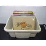 A collection of 12" vinyl records including Neil Young, Elton John, Barry White, Johnny Cash, Paul