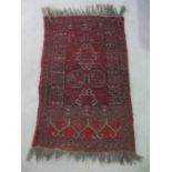 A hand woven red ground Eastern prayer rug, 106cm x 67cm