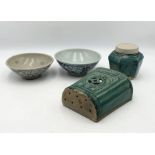 A collection of Oriental glazed pottery including two hand painted bowls, a wall sconce and a