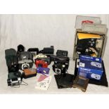 A collection of vintage cameras including a Kodak Kodascope, Konica Pop etc