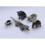 A collection of novelty pincushions in the form of pigs and crocodile along with a brass nib brush