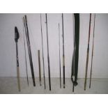 A collection of Shakespeare, Stalker and Shimano fishing rods plus a net