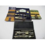 A leather cased sewing kit along with two needle cases and a drawing set