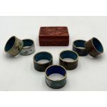 A collection of Cloisonne napkin rings along with a cinnabar lacquer box