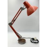 A vintage red anglepoise lamp