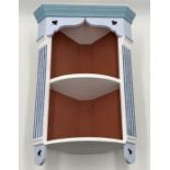 A small painted wall hanging corner unit