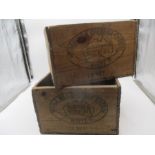 Two wooden crates. Each end is marked with advertising "Whole Milk Cheddar Cheese - White -