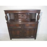 An oak court cupboard with carved decoration