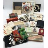 A collection of various vintage ephemera including cigarette cards, greetings cards, postcards,