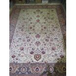 A cream ground rug with red and blue decoration - approx. 400cm x 300cm