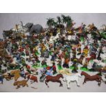 A large collection of plastic toy figurines including Britains cowboys, Indians, soldiers,