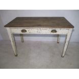 A rustic pine kitchen table with two drawers.