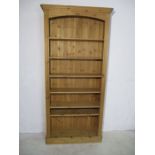 A tall pine bookcase.