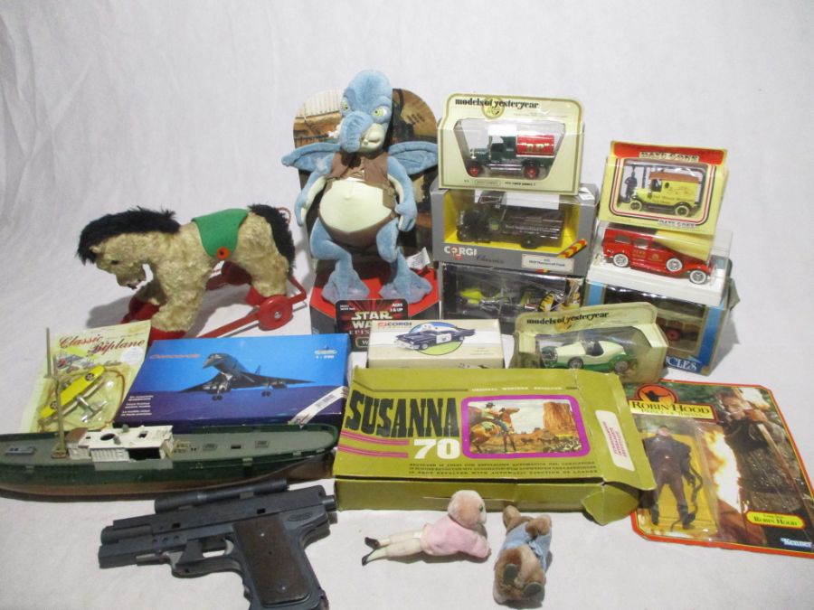 A collection of various toys including a small selection of boxed die-cast vehicles, toy guns, small