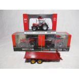 A collection of three boxed die-cast tractors (1:32 scale) including a Case Magnum 7120, Case Magnum