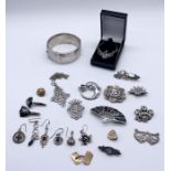 A collection of hallmarked and 925 silver jewellery including silver cap badge, along with a