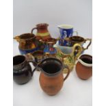 A collection of Victorian and later jugs including copper lustre etc.