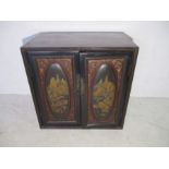 A Japanese 19th Century lacquered cabinet with hand painted decoration to doors