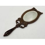 An Art Nouveau carved wooden hand-held dressing mirror