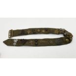 A British Army belt with numerous military cap badges and buttons including Royal Signals, Royal