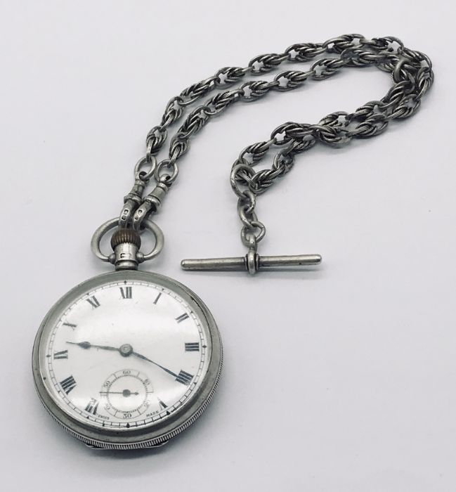 A hallmarked silver pocket watch with subsidiary second dial on a hallmarked silver Albert