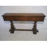 A Victorian mahogany narrow console table with three drawers