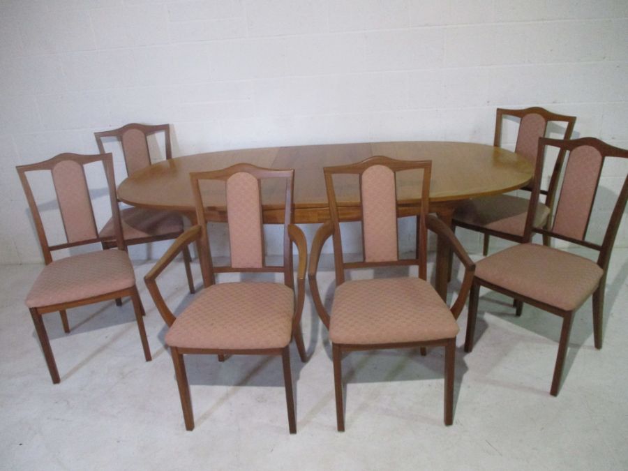 A Nathan extending dining table, along with six matching chairs including two carvers.
